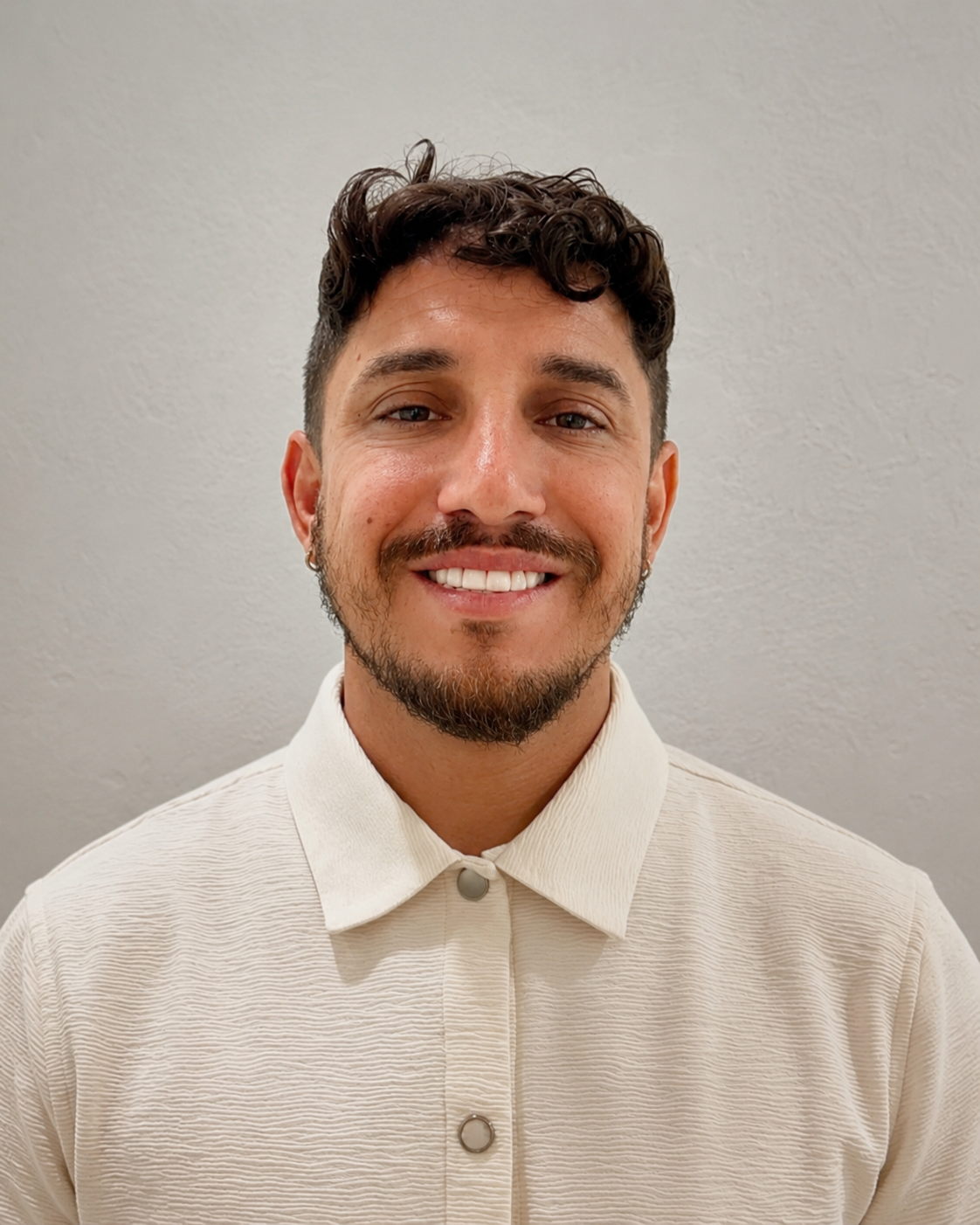 CEO of a custom blinds and shades company smiling in a professional headshot for a window treatments and window coverings business.